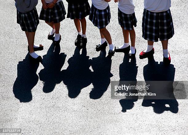 uniformed catholic school girls on the playground. - school uniforms stock-fotos und bilder