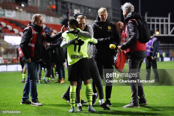 Lion Semic of Borussia Dortmund celebrates with staff following their sides victory after the UEFA Youth League Round Of Sixteen match between...