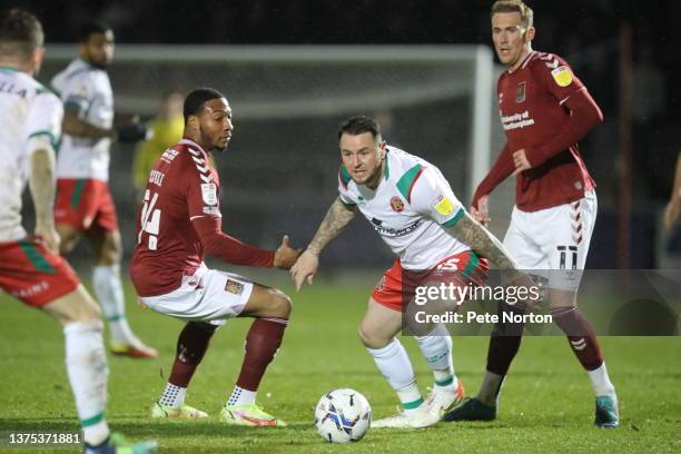 Lee Tomlin of Walsall looks to move past Ali Koiki and Mitch Pinnock of Northampton Town during the Sky Bet League Two match between Northampton Town...