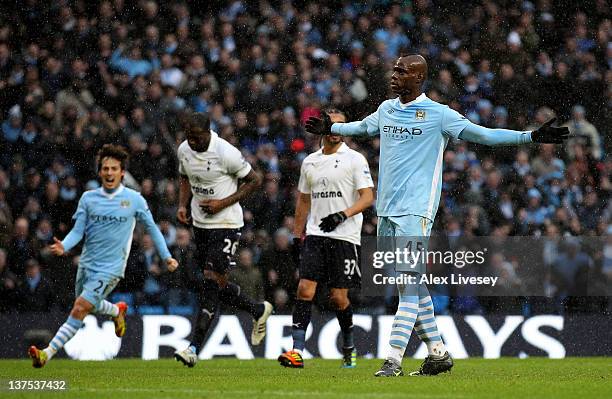 Mario Balotelli of Manchester City celebrates scoring his team's third goal from a penalty during the Barclays Premier League match between...