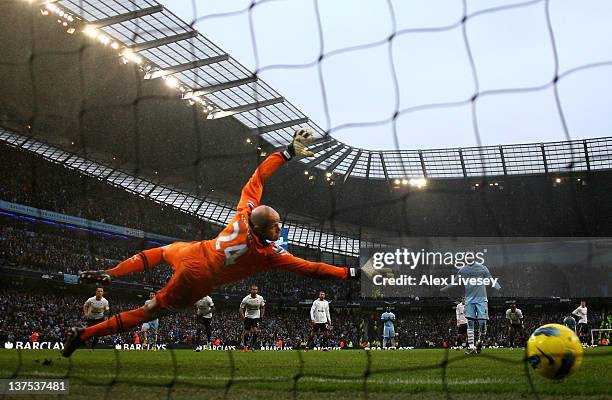 Brad Friedel of Tottenham Hotspur is unable to stop Mario Balotelli of Manchester City scoring his team's third goal from a penalty during the...