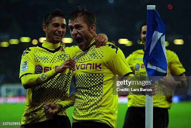 Jakub Blaszczykowski of Dortmund celebrates with team mate Moritz Leitner after scoring his teams fourth goal during the Bundesliga match between...