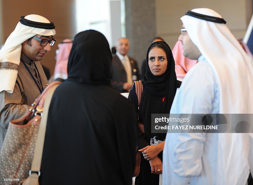 Saudi men and women chat at a hotel in R