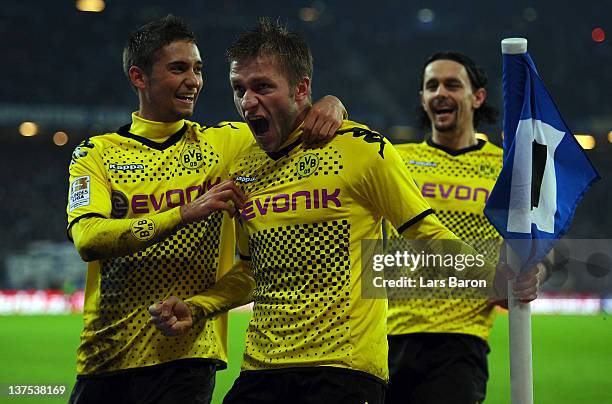 Jakub Blaszczykowski of Dortmund celebrates with team mate Moritz Leitner and Neven Subotic after scoring his teams fourth goal during the Bundesliga...