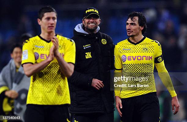 Head coach Juergen Klopp of Dortmund celebrates with Robert Lewandowski and Mats Hummels after winning the Bundesliga match between Hamburger SV and...