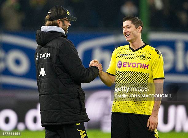 Dortmund's head coach Juergen Klopp congratulates Dortmund's Polish striker Robert Lewandowski at the end of the German first division Bundesliga...