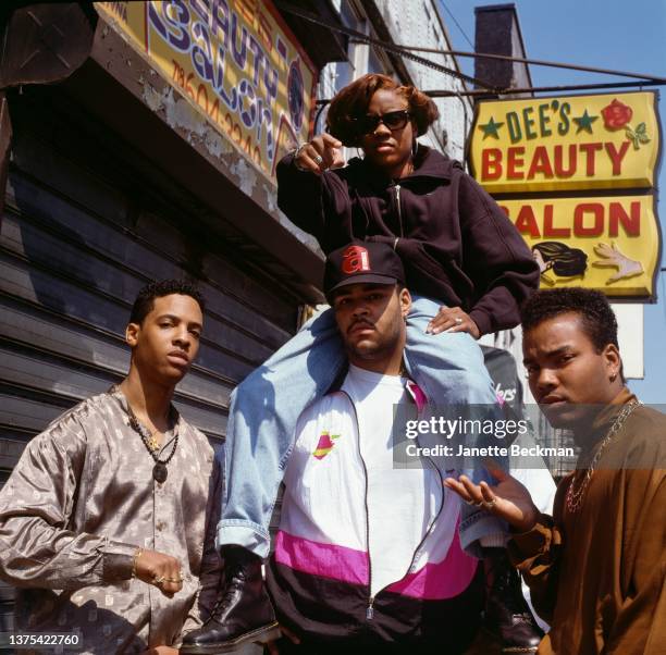 American rapper and DJ, MC Lyte, riding on the shoulders of DJ and producer, Big Drew, Brooklyn, New York City, 1990. With them are promoter Tony...