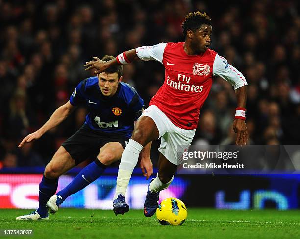 Alex Song of Arsenal evades Michael Carrick of Manchester United during the Barclays Premier League match between Arsenal and Manchester United at...