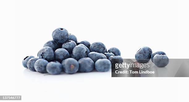 close up of pile of blueberries - bluebearry stock pictures, royalty-free photos & images