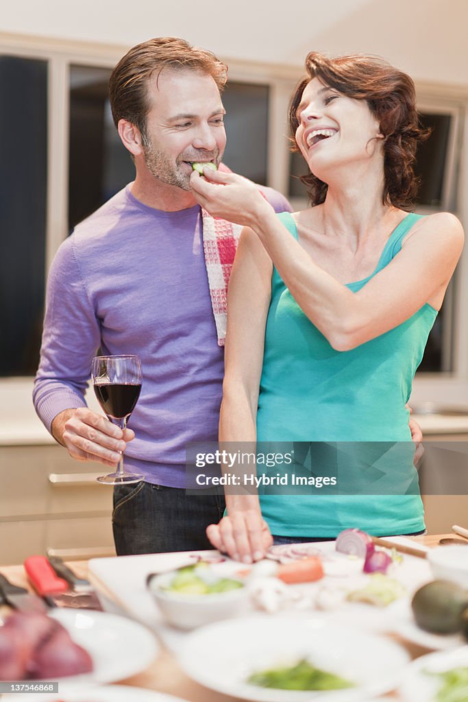 Couple eating and cooking dinner