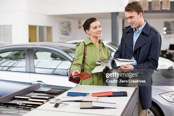 couple picking out swatches in showroom - new guidance stock pictures, royalty-free photos & images