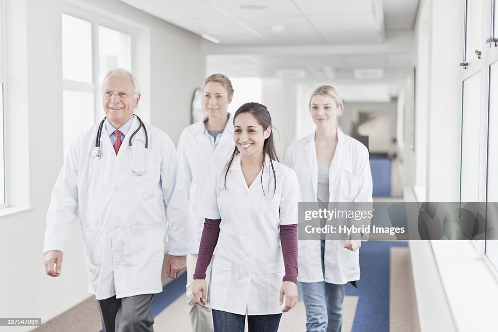 Doctors and nurses walking in hospital