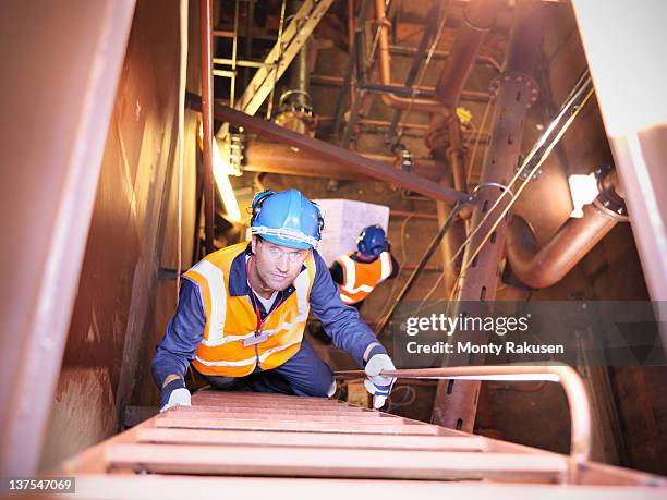 engineer climbing staircase in ship - shipbuilders stock pictures, royalty-free photos & images