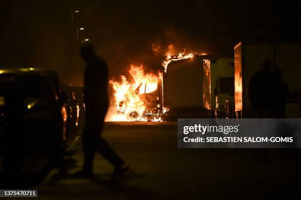 Man watches a truck burn in Nantes, western France on early July 1 four days after a 17-year-old man was killed by police in Nanterre, a western...