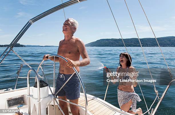 older couple relaxing on sailboat - hose stock pictures, royalty-free photos & images