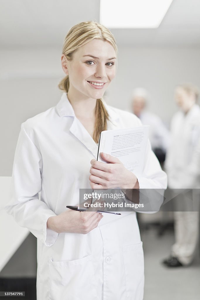 Scientist with notes in pathology lab