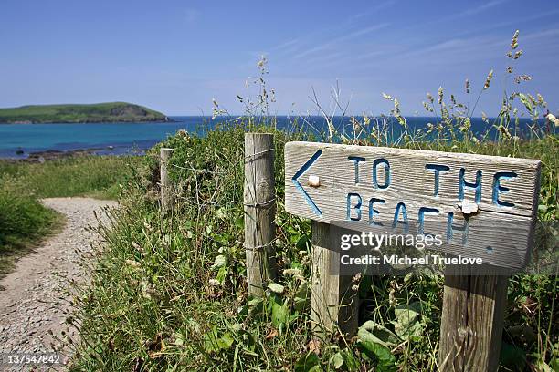 sign with directions to the beach - beach sign stock pictures, royalty-free photos & images