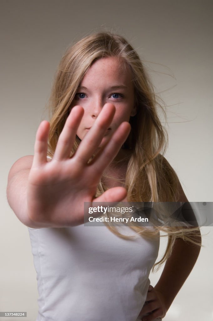 Teenage girl making stop gesture