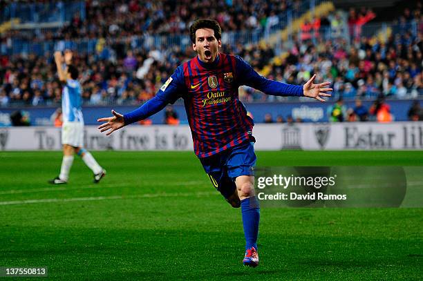 Lionel Messi of FC Barcelona celebrates after scoring the opening goal during the La Liga match between Malaga CF and FC Barcelona at Rosaleda...