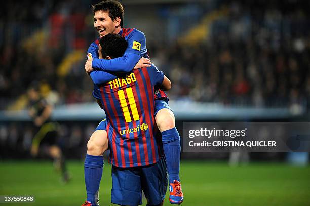 Barcelona's Argentinian forward Lionel Messi celebrates with Barcelona's midfielder Thiago Alcantara after scoring against Malaga during a Spanish...