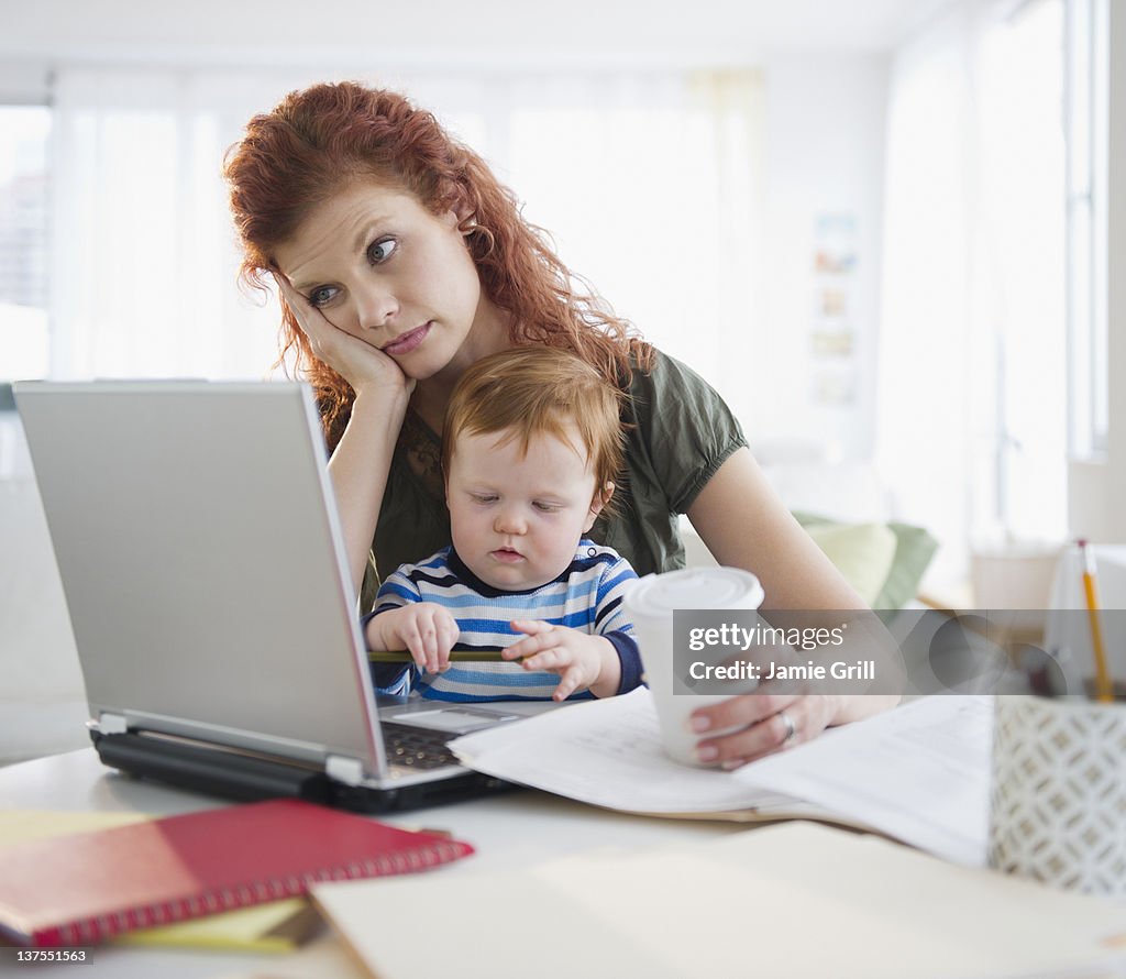 Mother working from home with baby, frustrated