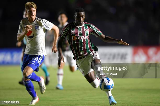 Andrés Llinas of Millonarios competes for the ball with Luiz Henrique of Fluminense during a second leg match between Fluminense and Millonarios as...