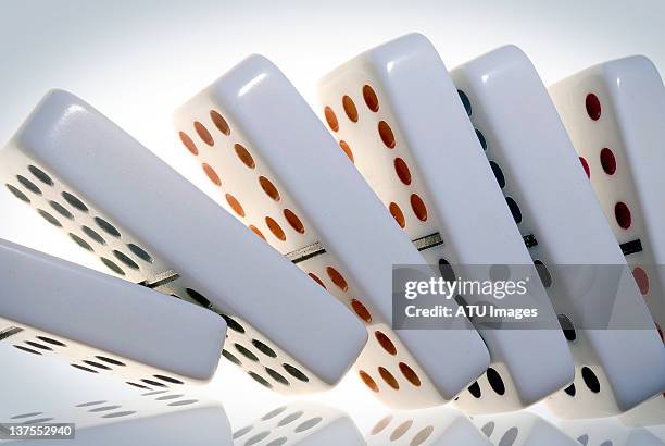 dominoes falling - domino stock-fotos und bilder