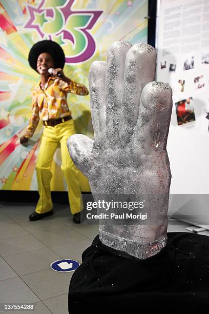 Two foot tall replica of Michael Jackson's white glove is unveiled with three different Michael Jackson wax figures from The Jackson Five, The 'Bad'...