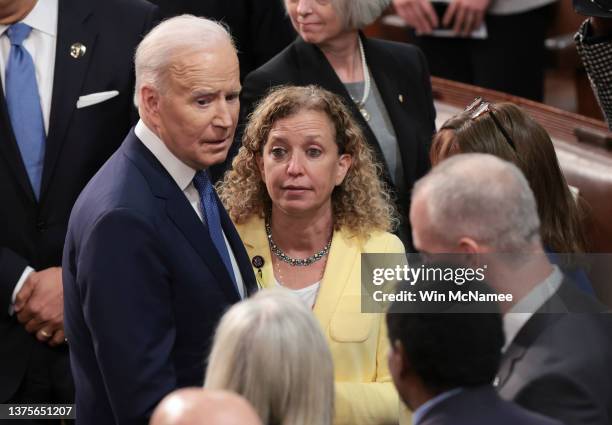 President Joe Biden talks to Rep. Debbie Wasserman Schultz after delivering the State of the Union address during a joint session of Congress in the...