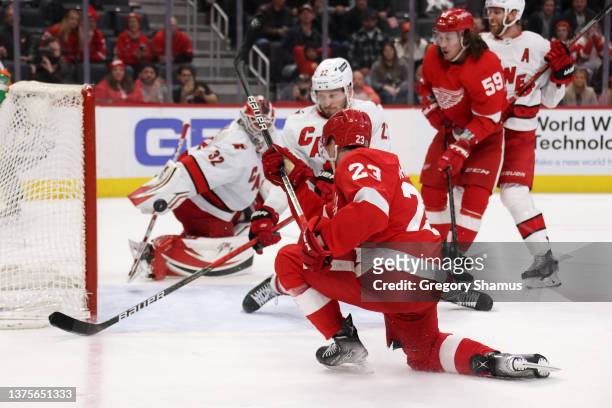 Lucas Raymond of the Detroit Red Wings scores the game winning goal past Antti Raanta of the Carolina Hurricanes for a 4-3 overtime win at Little...