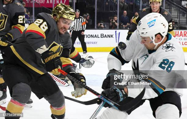 William Carrier of the Vegas Golden Knights watches the puck bounce off of Timo Meier of the San Jose Sharks in the first period of their game at...