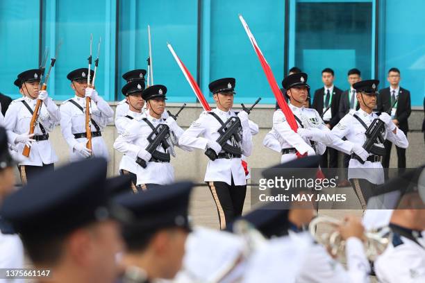 Honour guards march during the flag-raising ceremony at the Golden Bauhinia Square to mark the 26th anniversary of the former British colony's return...