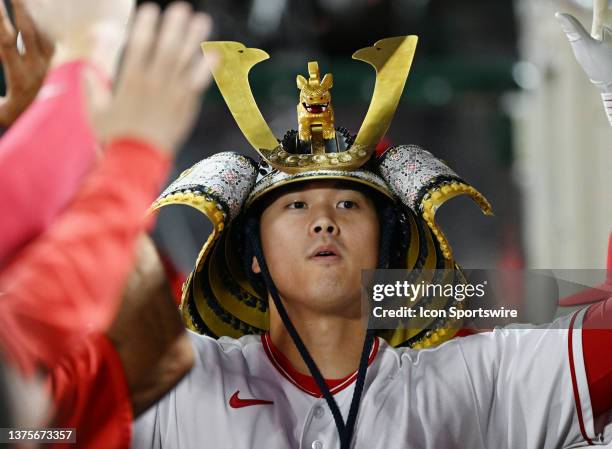 Los Angeles Angels designated hitter Shohei Ohtani wearing a kabuto in the dugout after hitting a solo home run in the sixth inning of an MLB...