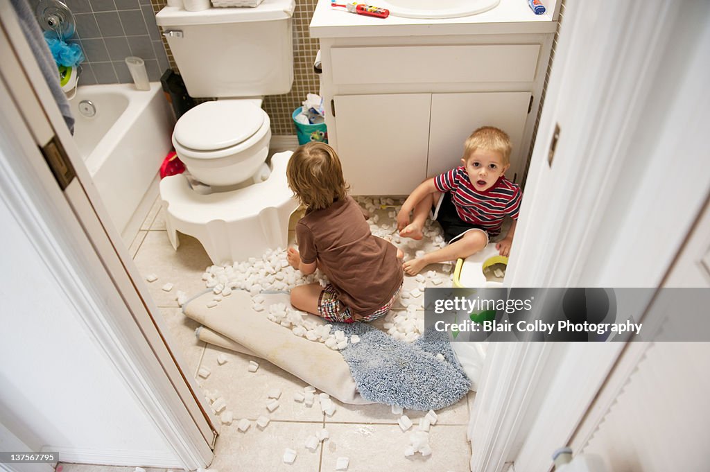 Boys making mess in bathroom