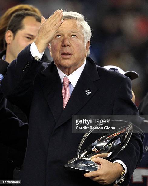 New England Patriots owner Robert Kraft gestures skyward in memory of Myra Kraft while holding the Lamar Hunt AFC Championship trophy. The New...
