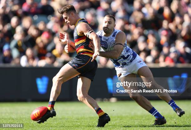 Ben Keays of the Crows kicks a goal from Griffin Logue of the Kangaroos during the 2023 AFL Round 16 match between the Adelaide Crows and the North...