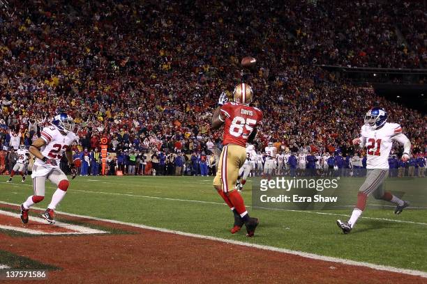 Vernon Davis of the San Francisco 49ers catches a 28-yard touchdown pass in the third quarter against Corey Webster of the New York Giants during the...