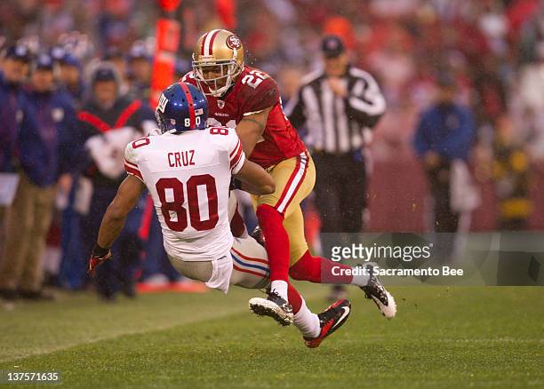 San Francisco 49ers cornerback Carlos Rogers tackles New York Giants wide receiver Victor Cruz in the second quarter of their NFC Championship game...