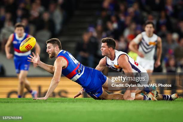 Marcus Bontempelli of the Bulldogs and Jaeger O'Meara of the Dockers compete for the ball during the 2023 AFL Round 16 match between the Western...