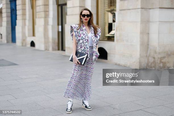 Influencer Alexandra Lapp wearing a multicolored janisae jacket with floral print by Isabel Marant, a white t-shirt by Isabel Marant, a long...