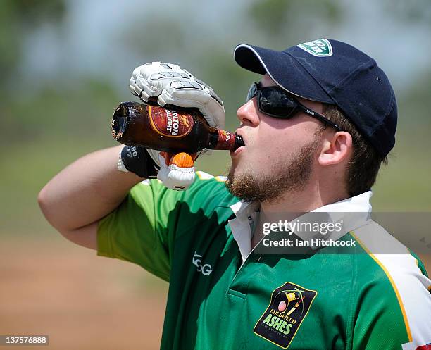 Jack MacDonald from the team 'Wolf Pack' drinks a beer on his way to bat during the 2012 Goldfield Ashes cricket competition on January 21, 2012 in...