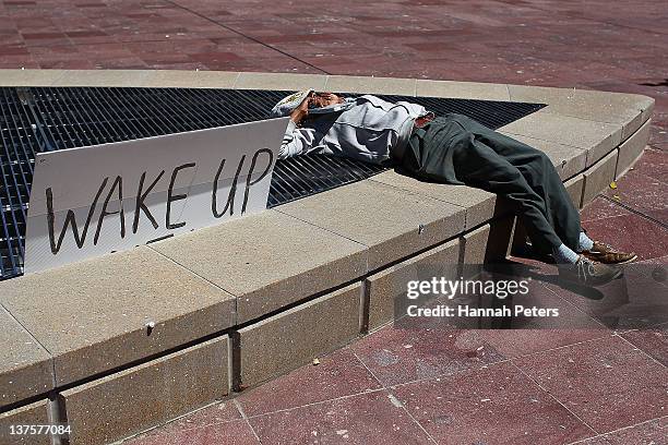 Protestor rests at Aotea Square on January 23, 2012 in Auckland, New Zealand. More than 30 police officers were on hand this morning when three...