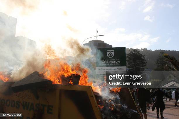 Fire burns in a rubbish skip on Bunny Street near Parliament and Victoria University after riot police moved to break up the occupation of...