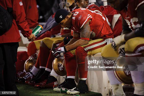 San Francisco 49ers Kyle Williams sits dejected on the bench after an overtime fumble in the NFC Championship game against the New York Giants at...