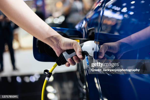 charging modern electric car - electric vehicle battery stock pictures, royalty-free photos & images