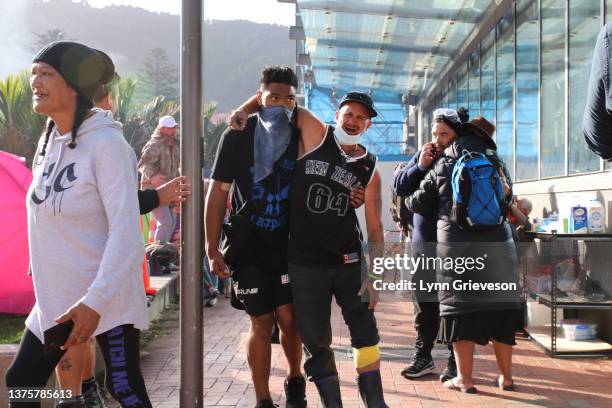 Protestors help injured demonstrators on Bunny Street near Parliament and Victoria University after riot police moved to break up the occupation of...