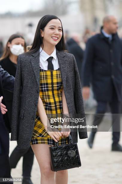 Kim Ji-soo aka Jisoo from Blackpink wears a white shirt from Dior, a black tie from Dior, a gray blazer jacket from Dior ,a white / yellow / black...