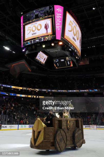 The Vegas Golden Knights Battle Wagon is driven on the ice as a tribute on the scoreboard is displayed for head coach Peter DeBoer's 500th career win...