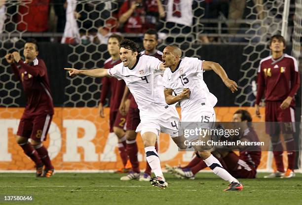 Ricardo Clark of USA celebrates with Michael Parkhurt after Clark scored against Venezuela during the final moments of the friendly match at...