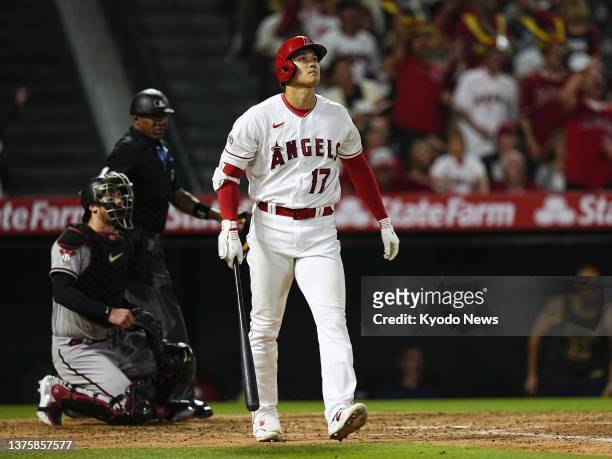 Shohei Ohtani of the Los Angeles Angels reacts after hitting his 30th homer of the season during the sixth inning of a baseball game against the...